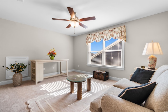 living area with ceiling fan and light carpet