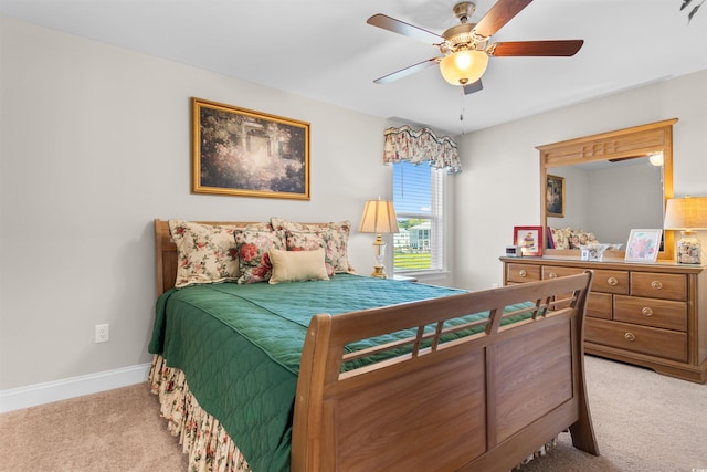 bedroom with ceiling fan and light colored carpet