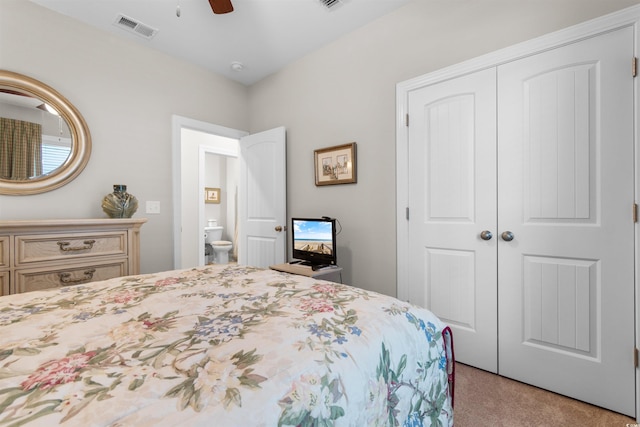 bedroom with ceiling fan, light colored carpet, and a closet