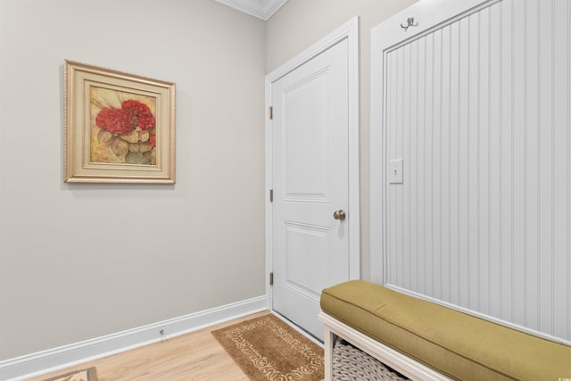 mudroom featuring wood-type flooring and crown molding