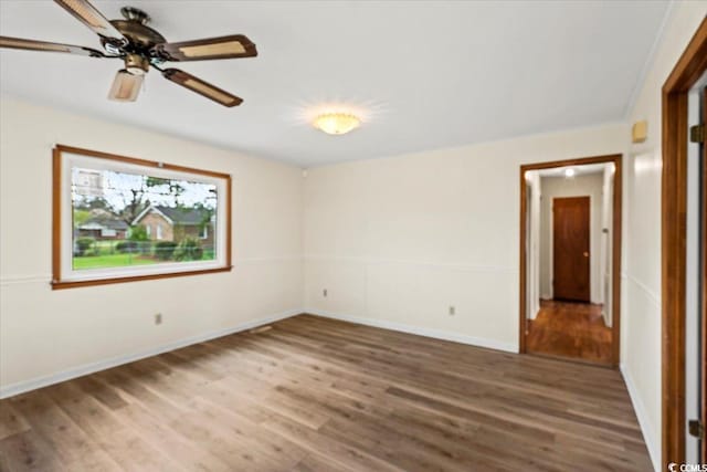 empty room with ceiling fan and hardwood / wood-style floors