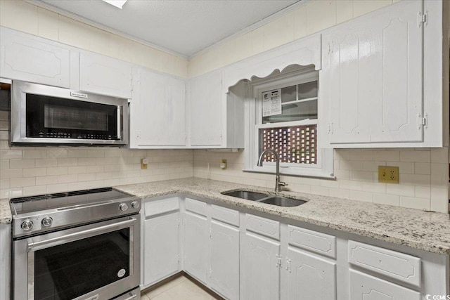 kitchen with white cabinets, appliances with stainless steel finishes, and sink