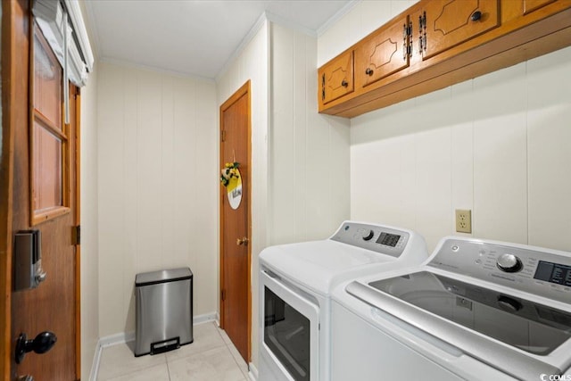 laundry room featuring crown molding, separate washer and dryer, light tile patterned flooring, and cabinets