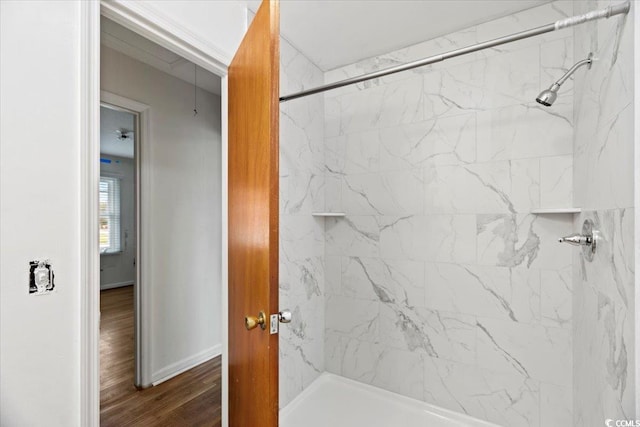 bathroom featuring hardwood / wood-style flooring and tiled shower