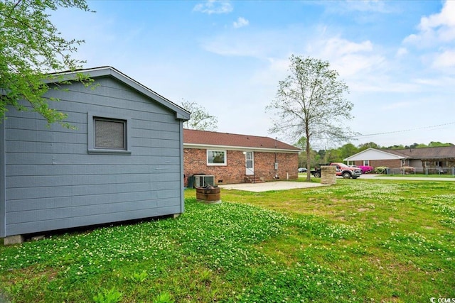 view of yard with a patio area and central air condition unit