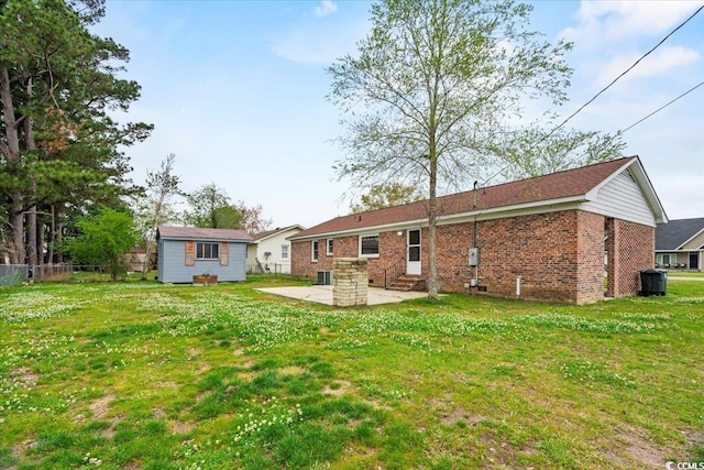 back of property featuring a patio and a yard