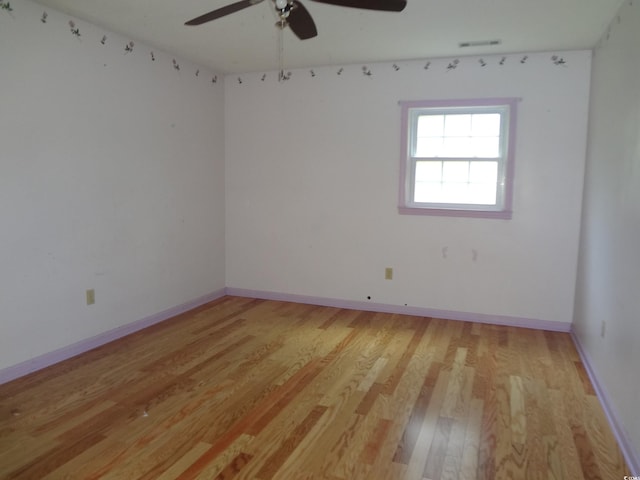 spare room featuring light hardwood / wood-style floors and ceiling fan