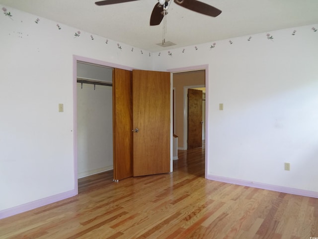 unfurnished bedroom with ceiling fan, a closet, and light hardwood / wood-style flooring