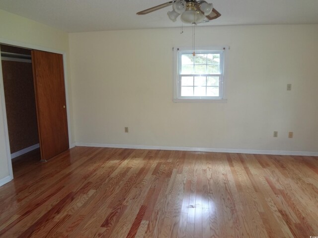 unfurnished bedroom featuring light wood-type flooring, a closet, and ceiling fan