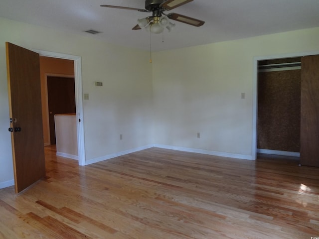 empty room with light wood-type flooring and ceiling fan