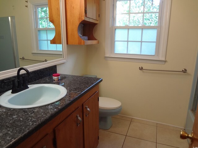 bathroom featuring toilet, vanity, and tile patterned floors