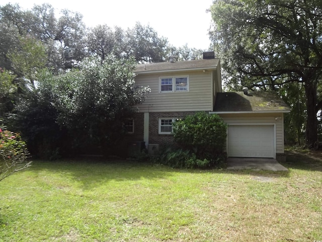 view of front facade with a garage and a front lawn