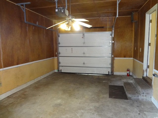 garage with ceiling fan and a garage door opener