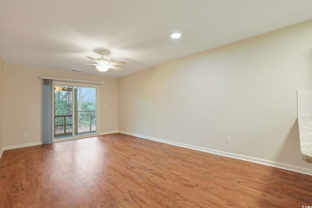 empty room with light wood-type flooring and ceiling fan