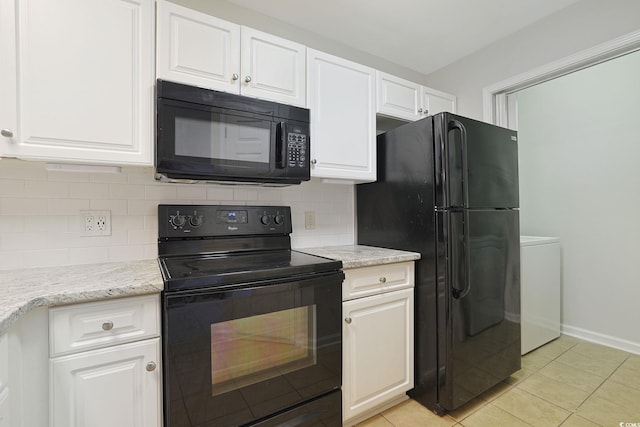 kitchen featuring light stone counters, light tile patterned flooring, white cabinetry, black appliances, and backsplash