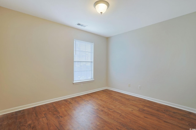 unfurnished room with hardwood / wood-style floors