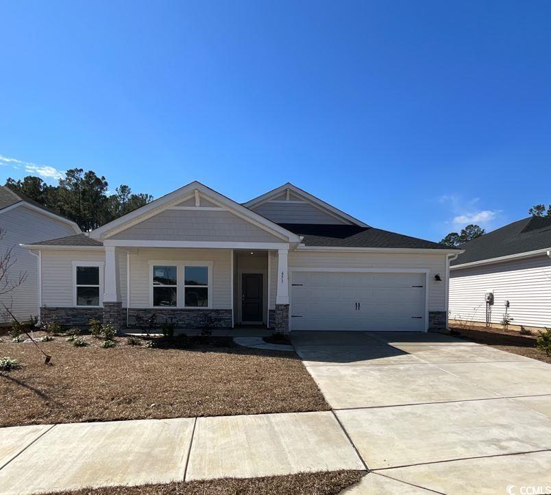 craftsman-style home with a front yard and a garage