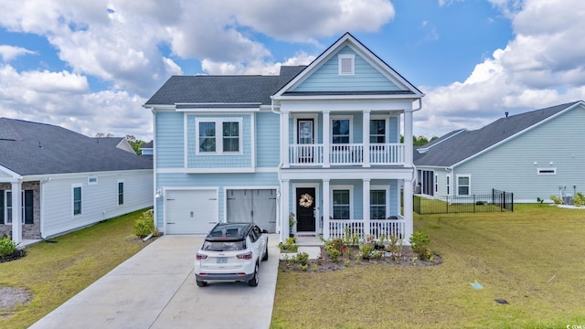 view of front of house with a front yard, a garage, and covered porch