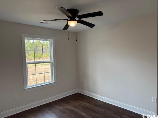 empty room with ceiling fan and dark hardwood / wood-style flooring