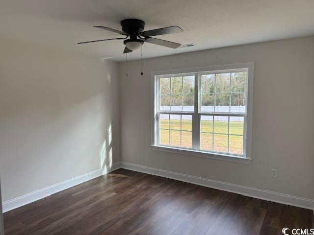 unfurnished room with ceiling fan and dark wood-type flooring