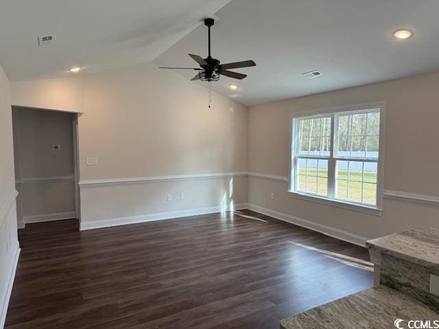 empty room featuring ceiling fan, dark wood-type flooring, and vaulted ceiling