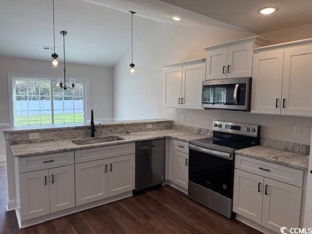 kitchen featuring kitchen peninsula, stainless steel appliances, sink, decorative light fixtures, and white cabinets