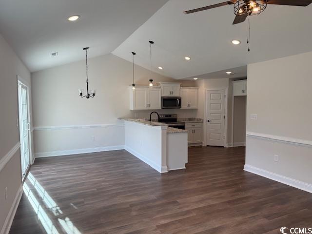 kitchen featuring kitchen peninsula, stainless steel appliances, pendant lighting, white cabinets, and lofted ceiling