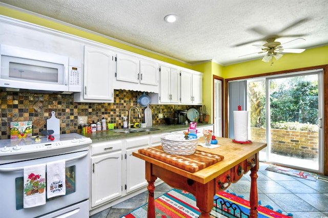 kitchen with ceiling fan, white cabinets, sink, white appliances, and backsplash