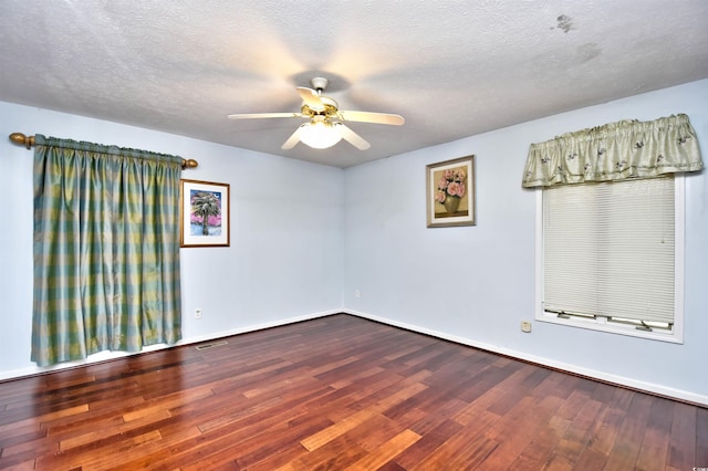 empty room featuring a textured ceiling, wood-type flooring, and ceiling fan