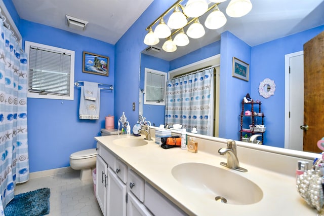 bathroom featuring vanity, toilet, and tile patterned floors