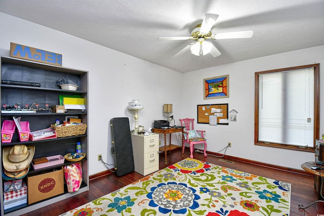 interior space with ceiling fan, dark wood-type flooring, and a textured ceiling