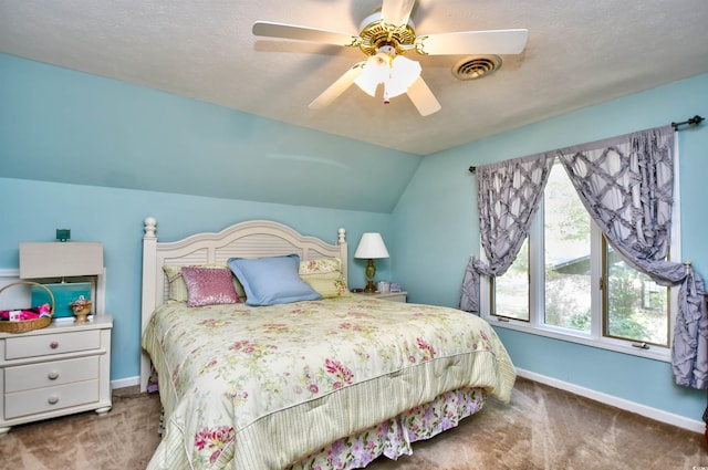 carpeted bedroom with lofted ceiling, ceiling fan, and a textured ceiling