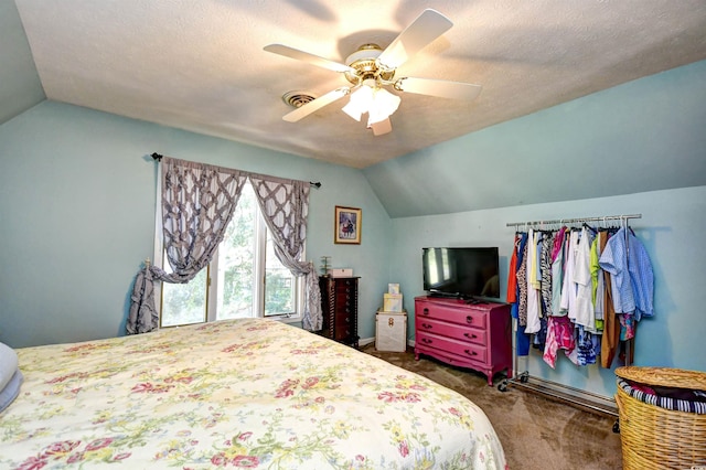 bedroom with dark colored carpet, ceiling fan, vaulted ceiling, and a textured ceiling