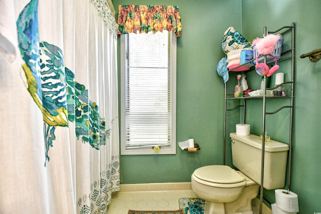 bathroom with toilet and tile patterned floors