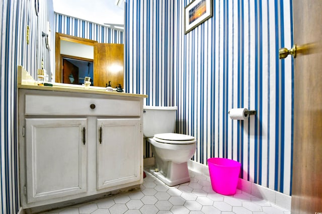 bathroom with vanity, tile patterned flooring, and toilet