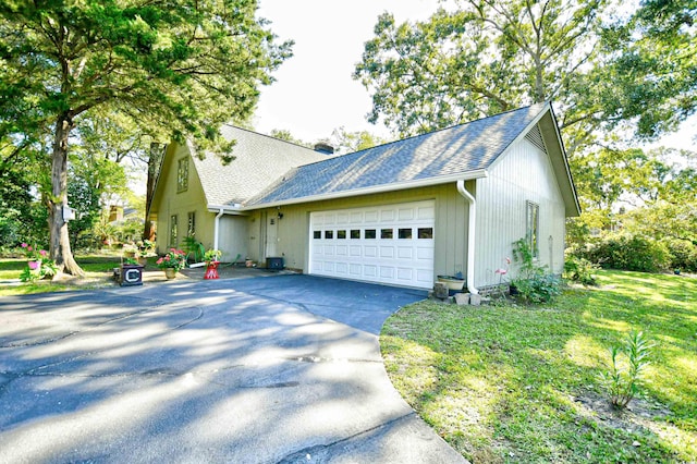 single story home with a garage and a front yard