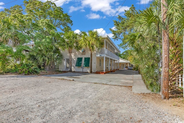 view of side of property with a balcony