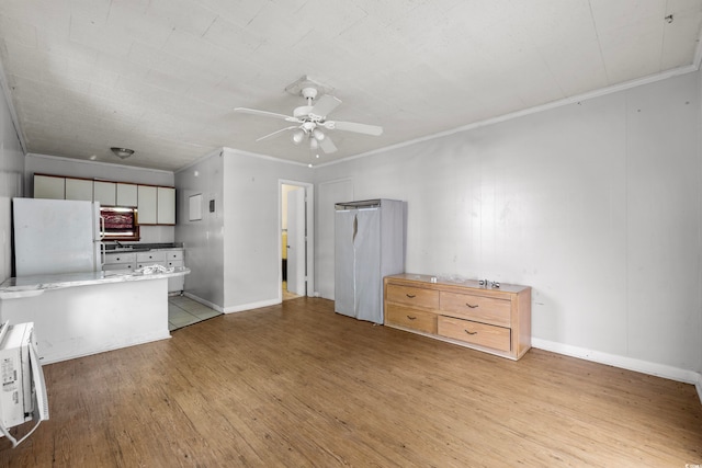 kitchen with light hardwood / wood-style flooring, crown molding, white cabinetry, white fridge, and ceiling fan