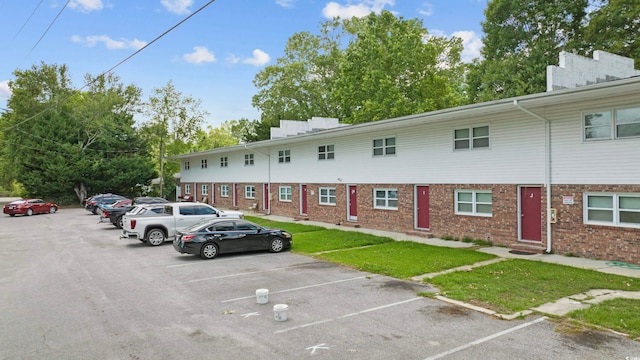 view of car parking with a lawn