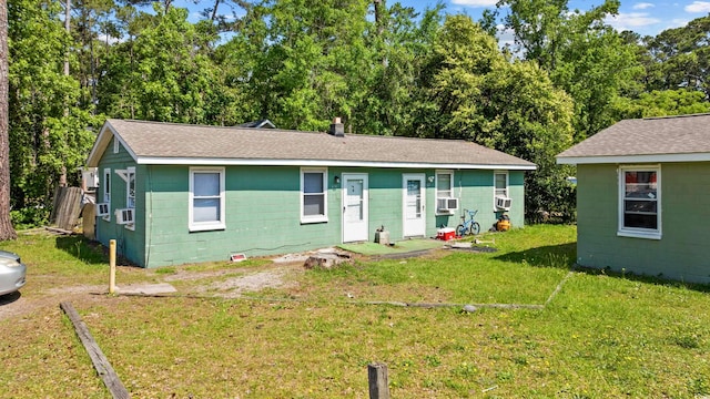 view of front of house featuring cooling unit and a front lawn