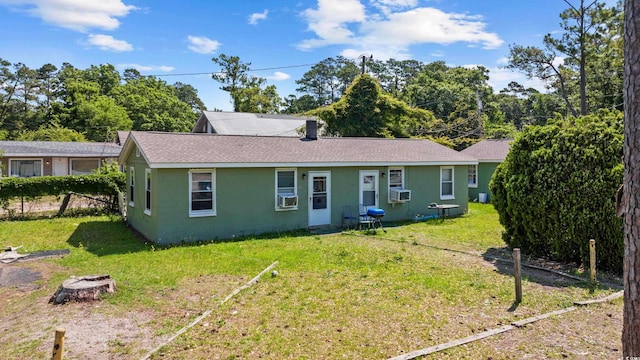 view of front of home with cooling unit and a front lawn