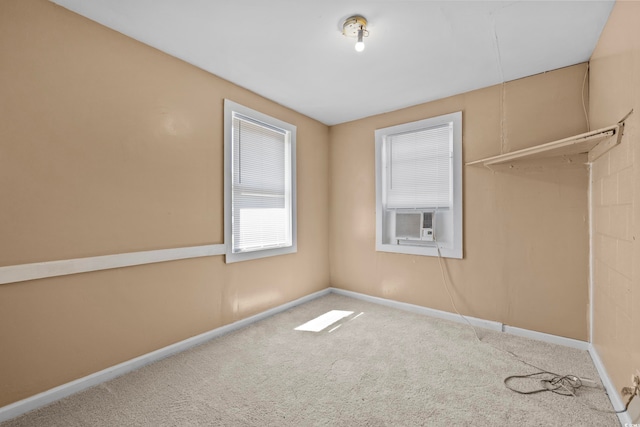 spare room featuring cooling unit and carpet floors