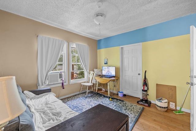 sitting room with a textured ceiling and hardwood / wood-style flooring