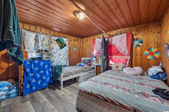 bedroom featuring wood walls, hardwood / wood-style floors, and wood ceiling