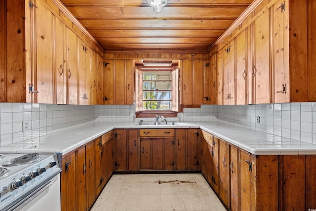 kitchen featuring wooden ceiling, sink, tile counters, backsplash, and white electric range