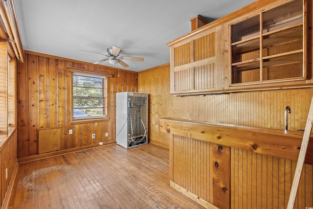 kitchen with wood walls and hardwood / wood-style floors