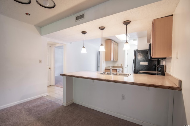 kitchen featuring kitchen peninsula, light carpet, sink, and pendant lighting