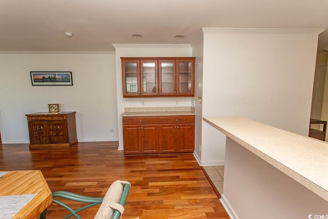 bar featuring hardwood / wood-style flooring and crown molding