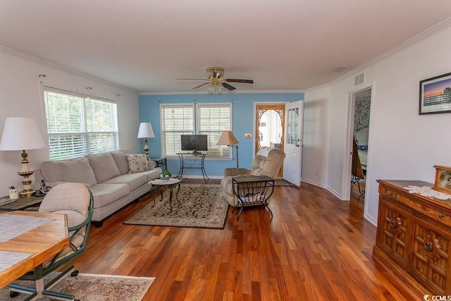 living room with hardwood / wood-style flooring, crown molding, and ceiling fan