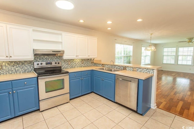 340 Walden Lake Rd, Conway, SC 29526 - kitchen featuring stainless steel appliances, a sink, under cabinet range hood, a peninsula, and blue cabinetry